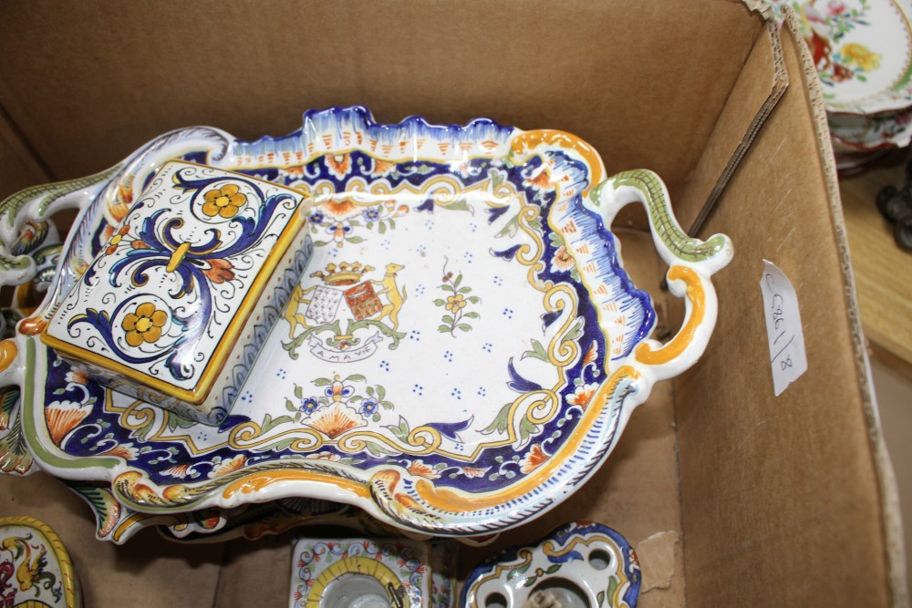 A collection of five St Malo faience dishes, a similar chamberstick, two inkwells, an unsigned oil lamp and a Deruta casket